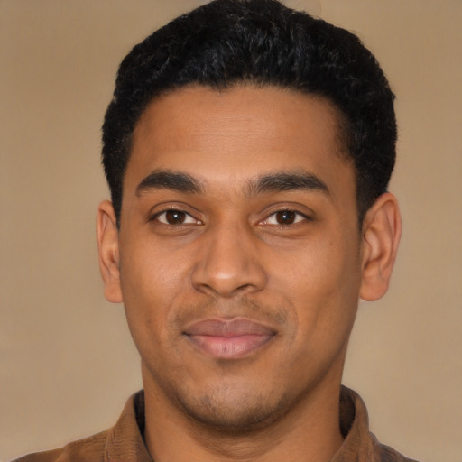 Joyful latino young-adult male with short  black hair and brown eyes
