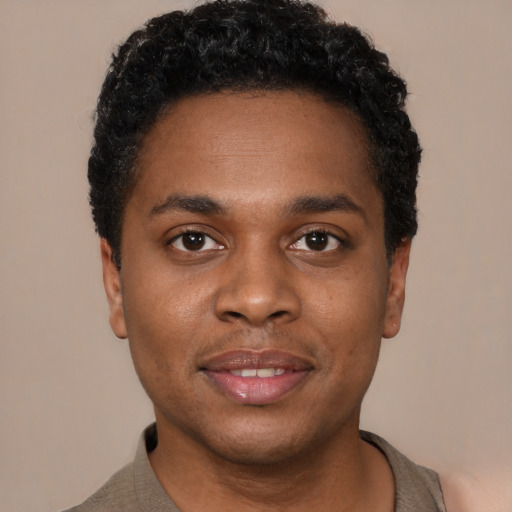 Joyful black young-adult male with short  black hair and brown eyes