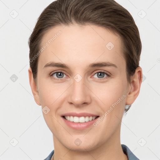 Joyful white young-adult female with short  brown hair and grey eyes