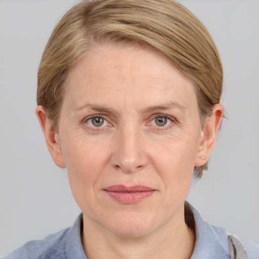 Joyful white adult female with medium  brown hair and blue eyes