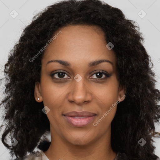 Joyful black young-adult female with long  brown hair and brown eyes