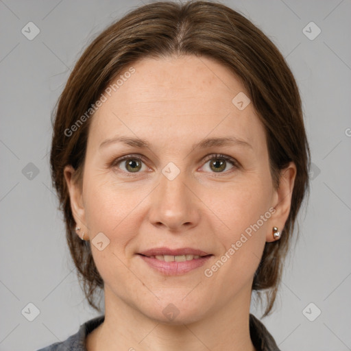 Joyful white adult female with medium  brown hair and grey eyes