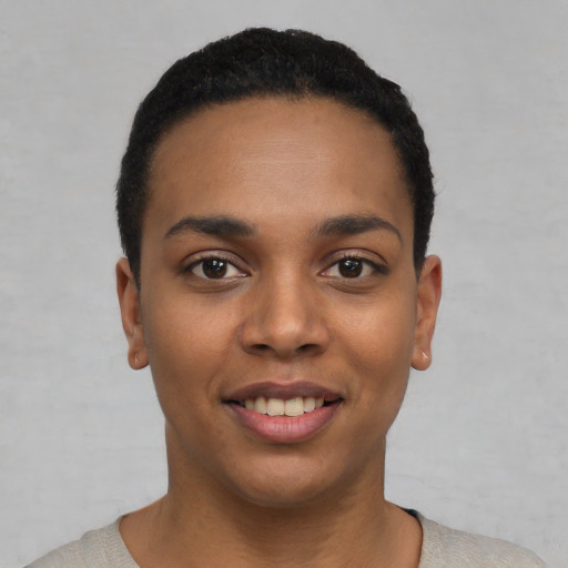 Joyful latino young-adult female with short  black hair and brown eyes