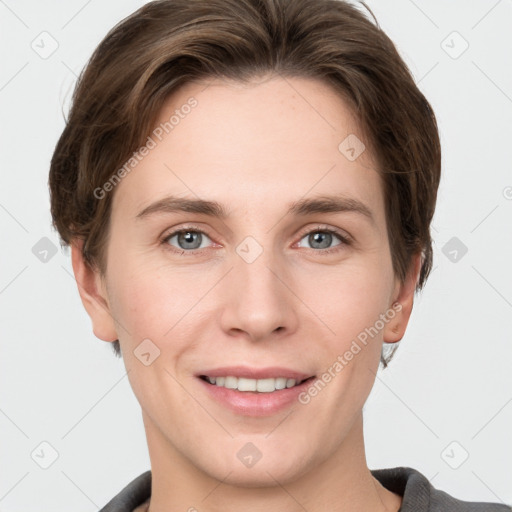 Joyful white young-adult female with short  brown hair and grey eyes