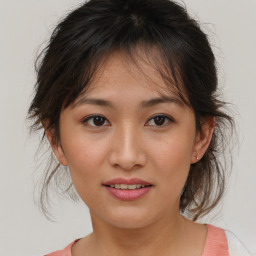 Joyful asian young-adult female with medium  brown hair and brown eyes