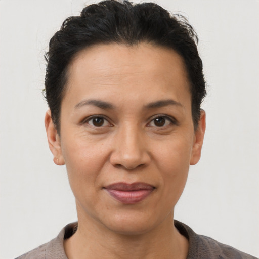 Joyful latino adult female with short  brown hair and brown eyes