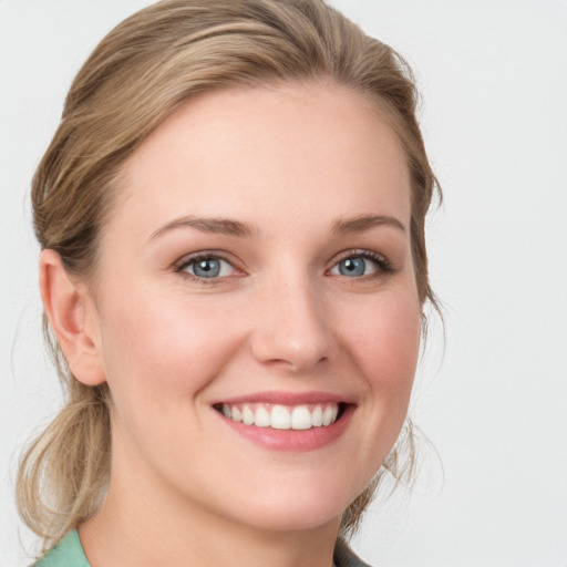 Joyful white young-adult female with medium  brown hair and blue eyes