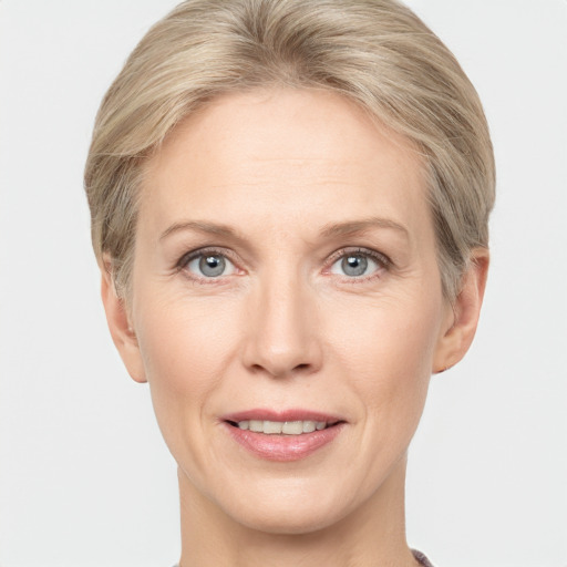 Joyful white adult female with short  blond hair and grey eyes