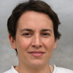 Joyful white adult female with short  brown hair and brown eyes