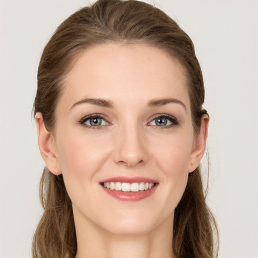 Joyful white young-adult female with long  brown hair and grey eyes