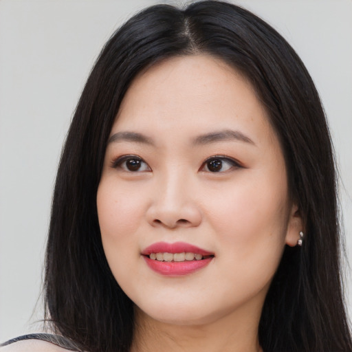 Joyful asian young-adult female with long  black hair and brown eyes