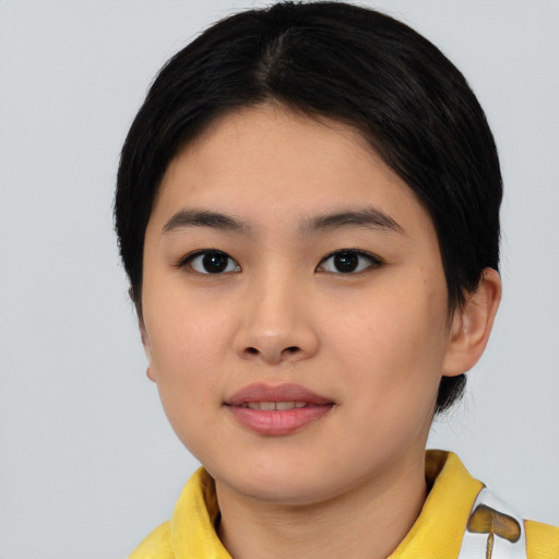 Joyful asian young-adult female with short  black hair and brown eyes