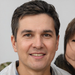 Joyful white adult male with short  brown hair and brown eyes