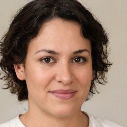 Joyful white adult female with medium  brown hair and brown eyes