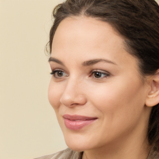 Joyful white young-adult female with medium  brown hair and brown eyes