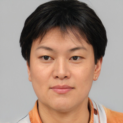 Joyful asian young-adult female with short  brown hair and brown eyes