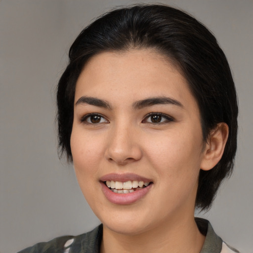 Joyful latino young-adult female with medium  brown hair and brown eyes
