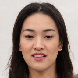 Joyful asian young-adult female with long  brown hair and brown eyes