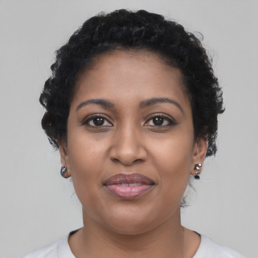 Joyful black young-adult female with short  brown hair and brown eyes