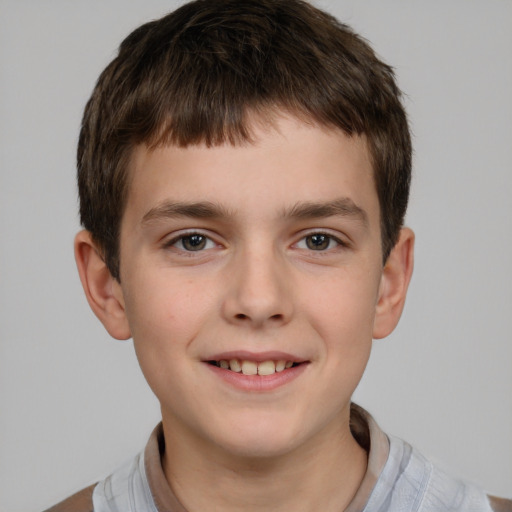 Joyful white child male with short  brown hair and brown eyes