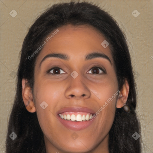 Joyful latino young-adult female with long  brown hair and brown eyes