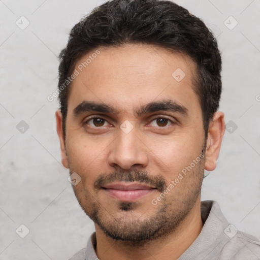 Joyful white young-adult male with short  black hair and brown eyes