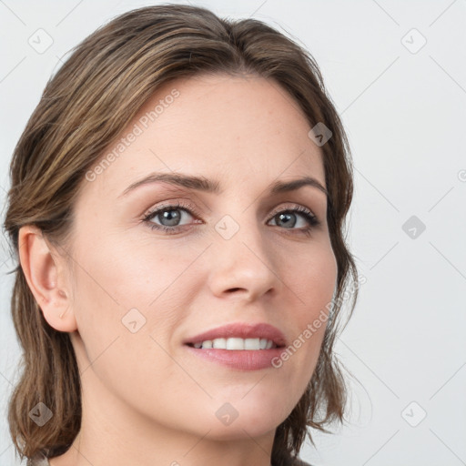 Joyful white young-adult female with long  brown hair and blue eyes