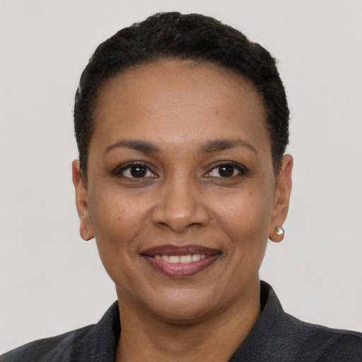 Joyful black adult female with short  black hair and brown eyes