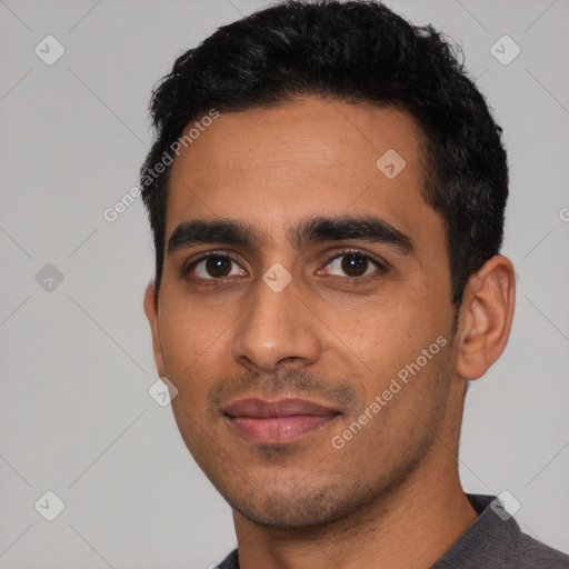 Joyful latino young-adult male with short  black hair and brown eyes