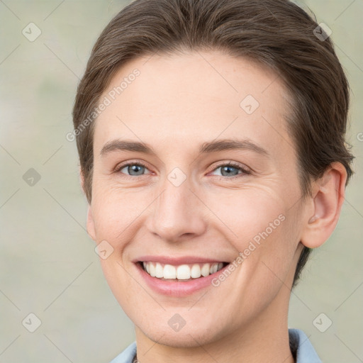 Joyful white young-adult female with short  brown hair and grey eyes