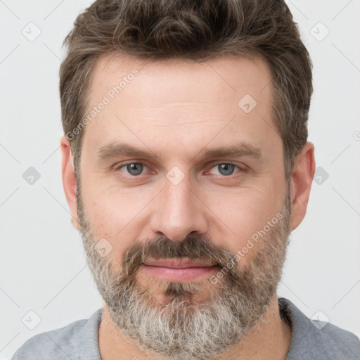 Joyful white adult male with short  brown hair and grey eyes