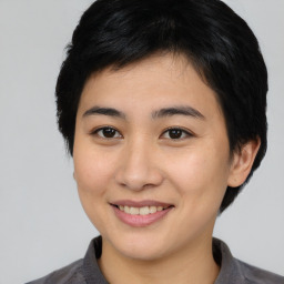 Joyful asian young-adult female with medium  black hair and brown eyes