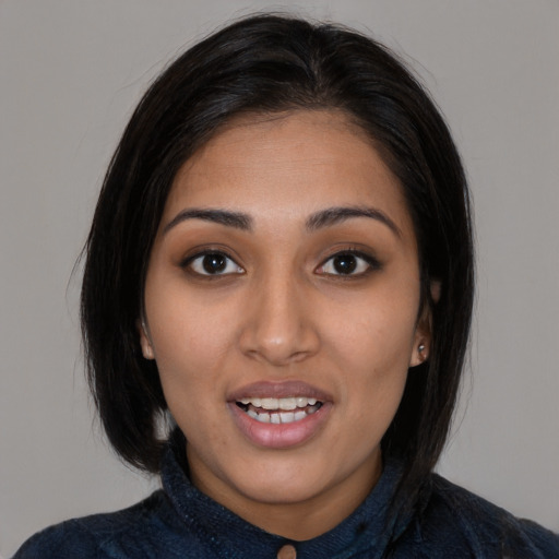 Joyful latino young-adult female with medium  black hair and brown eyes