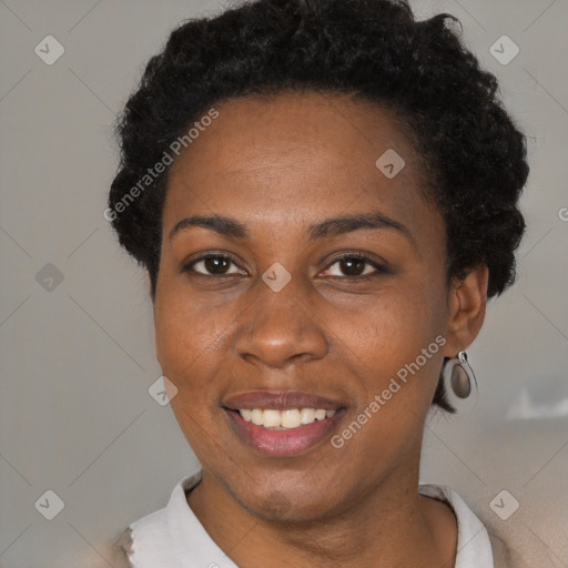 Joyful black adult female with short  black hair and brown eyes