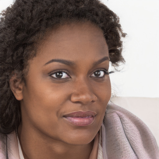 Joyful black young-adult female with medium  brown hair and brown eyes