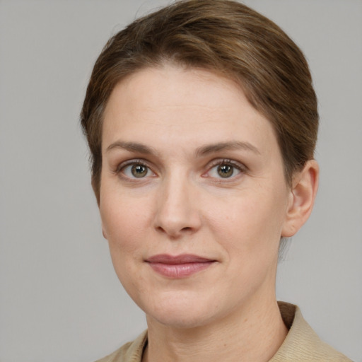 Joyful white young-adult female with short  brown hair and grey eyes