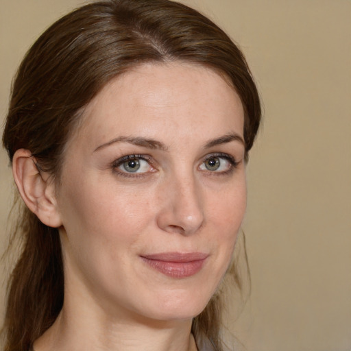 Joyful white adult female with medium  brown hair and brown eyes