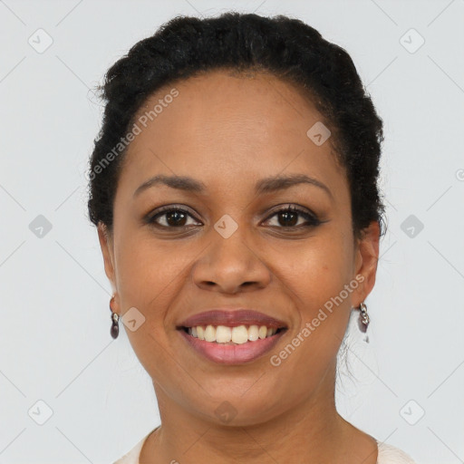 Joyful black young-adult female with short  black hair and brown eyes