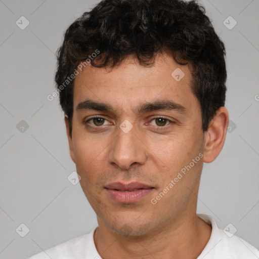 Joyful white young-adult male with short  black hair and brown eyes