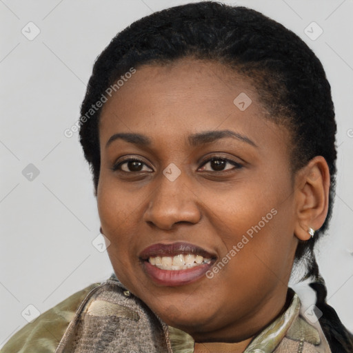 Joyful black young-adult female with short  black hair and brown eyes