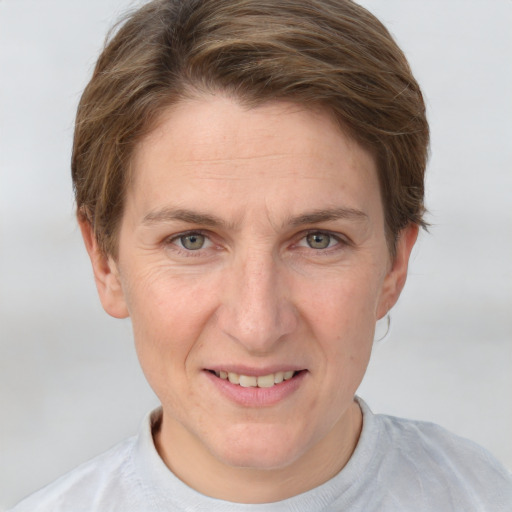 Joyful white adult female with short  brown hair and grey eyes