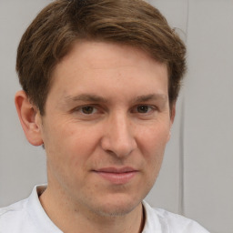 Joyful white adult male with short  brown hair and brown eyes