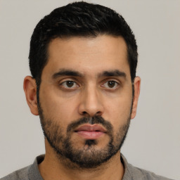 Neutral latino young-adult male with short  black hair and brown eyes