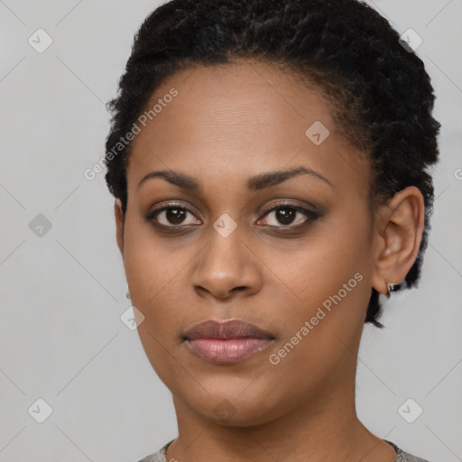 Joyful black young-adult female with short  black hair and brown eyes