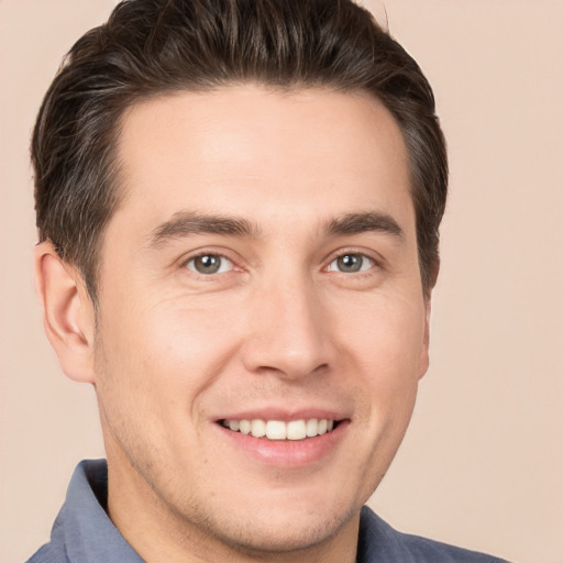 Joyful white young-adult male with short  brown hair and brown eyes