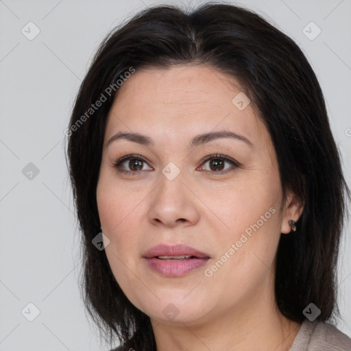 Joyful white adult female with long  brown hair and brown eyes