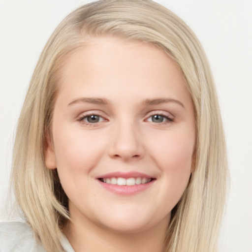 Joyful white young-adult female with long  brown hair and blue eyes