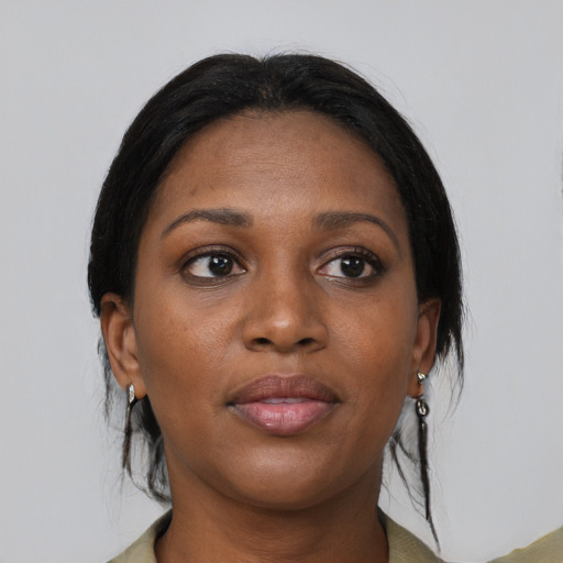 Joyful black young-adult female with medium  black hair and brown eyes