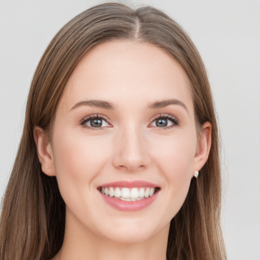 Joyful white young-adult female with long  brown hair and grey eyes