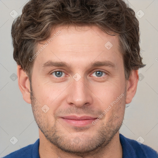 Joyful white adult male with short  brown hair and grey eyes